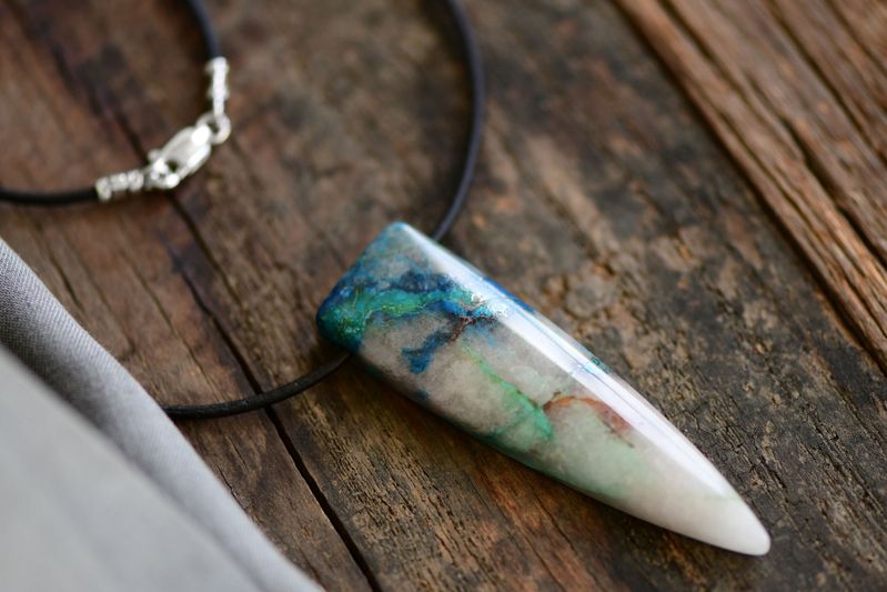 chrysocolla pendant is the centerpiece of this leather cord necklace. Sterling closure.