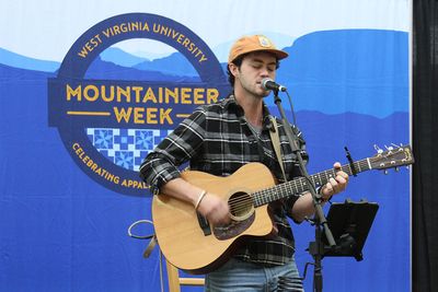 Samuel James sings and plays guitar on the Mountaineer Week stage