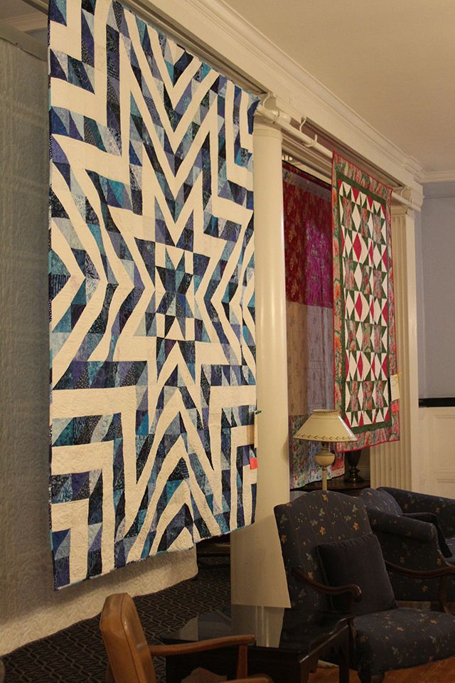 Two quilts hanging in the Elizabeth Moore Hall main lobby