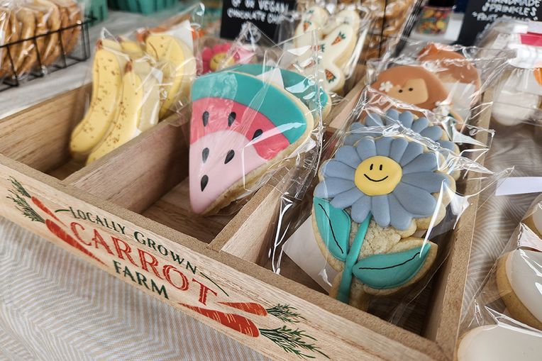 Cookies decorated to resemble bananas, watermelon slices and daisies