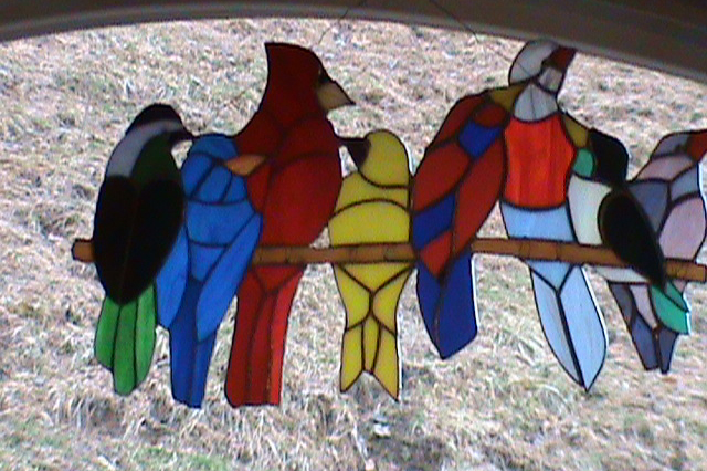 Stained glass depicting birds perched on a branch