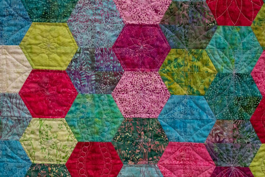 multicolored quilt with hexagonal pattern