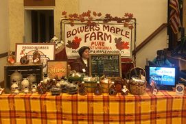 Table with maple syrup, maple candy and maple coated nuts displayed