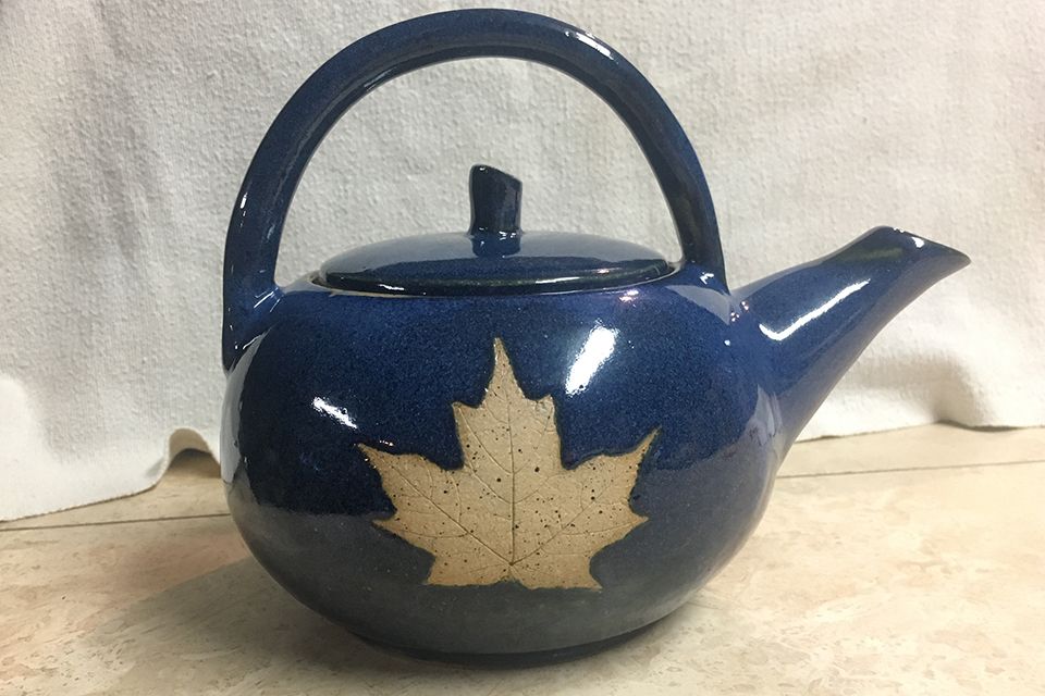 pottery teapot with maple leaf etching
