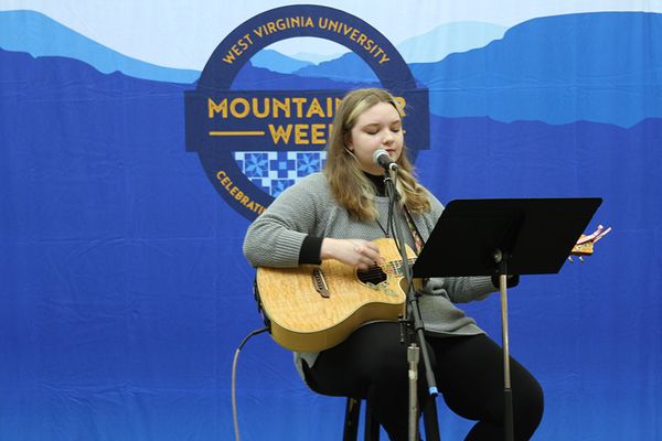 Lexi Mank sings and plays guitar on the Mountaineer Week stage