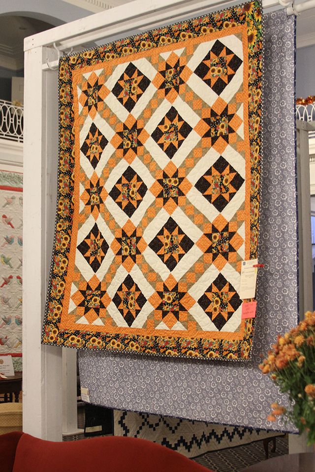 A sunflower motif quilt on display during the 2022 Quilt Show